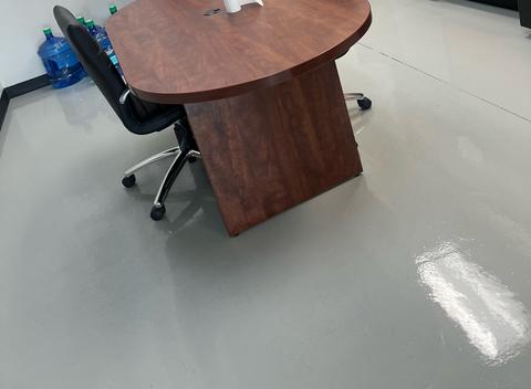 An office break room with its table, chairs and floor freshly cleaned.