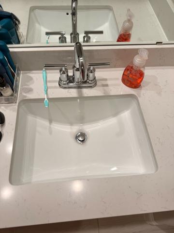 A close-up of a gleaming bathroom sink and faucet.