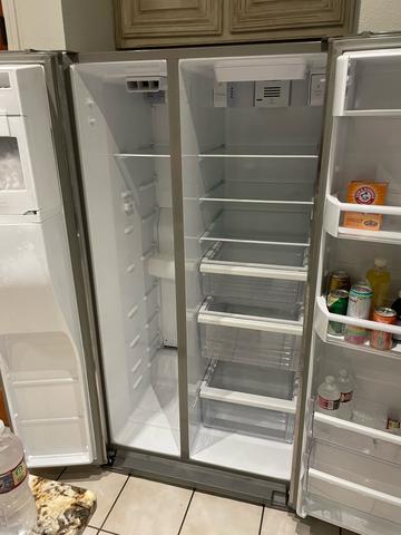 An open, empty refrigerator with clean shelves and drawers after a move-out cleaning.