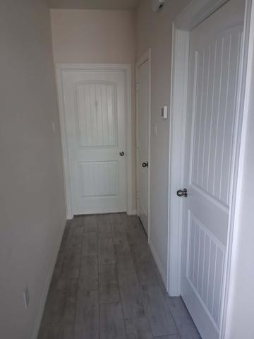 A hallway with clean baseboards and floors after a move-out cleaning.