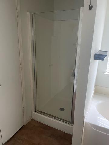 A clean walk-in shower after a move-out cleaning.