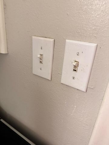 A close-up of light switch plates wiped clean.