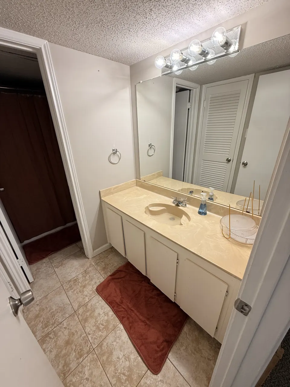 Clean bathroom vanity, sink and mirror after a residential cleaning