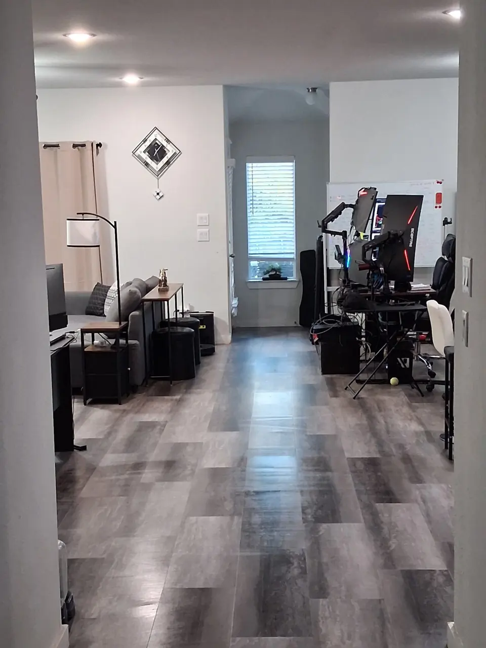 Clean living room with gray vinyl plank floors after a residential cleaning